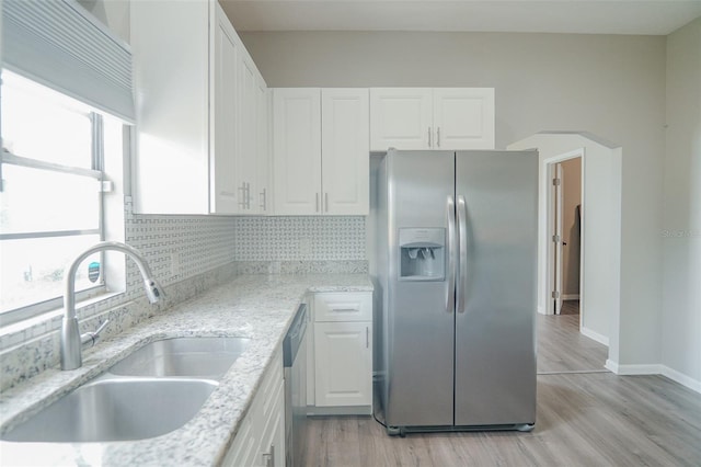 kitchen featuring light wood-style floors, a sink, white cabinetry, and appliances with stainless steel finishes