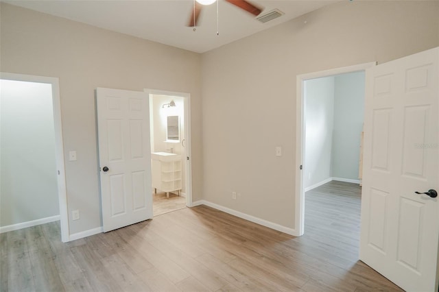 unfurnished bedroom featuring baseboards, visible vents, and light wood-style floors