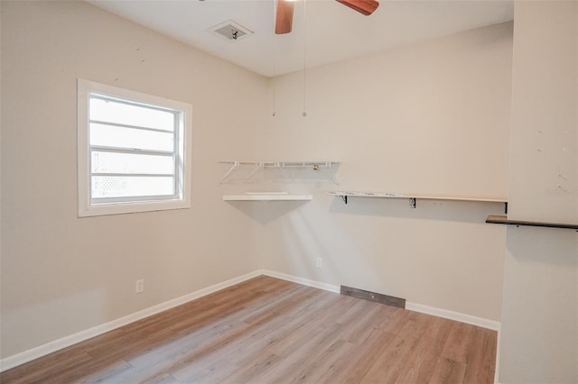 walk in closet featuring wood finished floors and ceiling fan