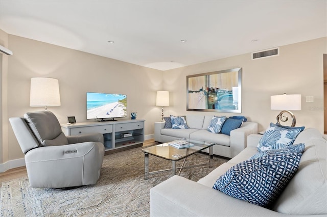 living area with visible vents, baseboards, recessed lighting, and wood finished floors