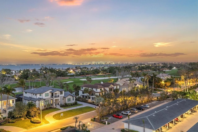 aerial view at dusk featuring a residential view