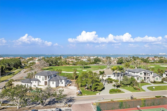 birds eye view of property with a water view, view of golf course, and a residential view