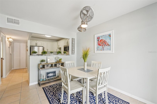 117 7th St N Unit 5, Bradenton Beach, FL 34217 - dining room with light tile patterned flooring and baseboards