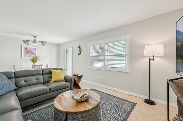 117 7th St N Unit 5, Bradenton Beach, FL 34217 - living room with light tile patterned flooring, baseboards, and a chandelier