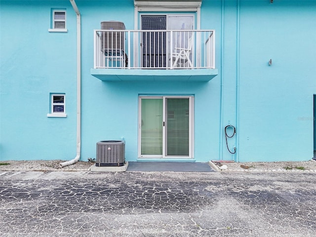 117 7th St N Unit 5, Bradenton Beach, FL 34217 - rear view of house featuring central air condition unit, a balcony, and stucco siding