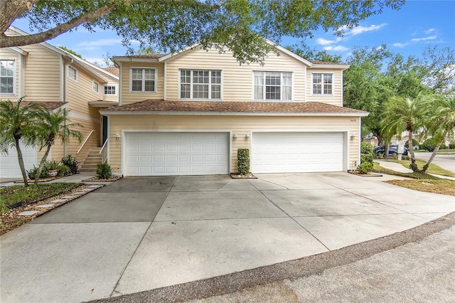 view of front of property with a garage and concrete driveway