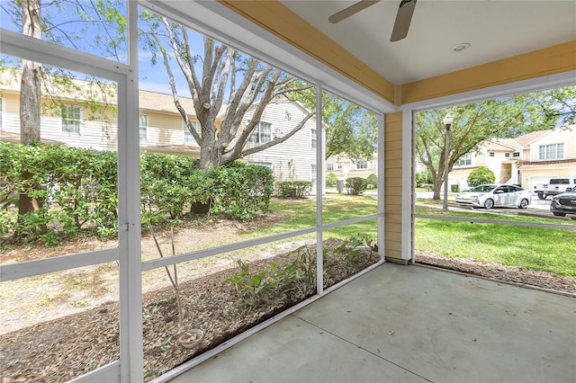 unfurnished sunroom featuring ceiling fan
