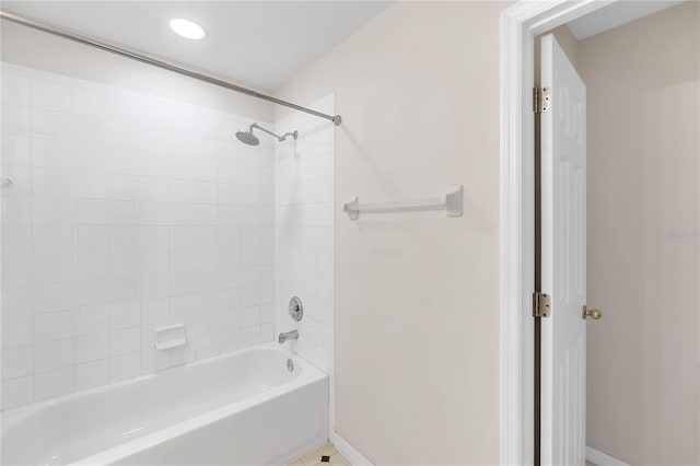 bathroom featuring baseboards and shower / bath combination