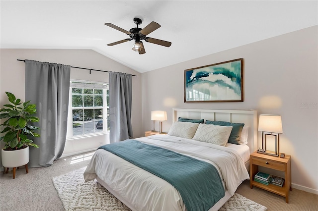 bedroom with carpet flooring, baseboards, a ceiling fan, and vaulted ceiling