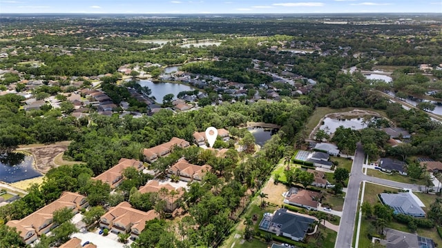 drone / aerial view featuring a water view and a residential view