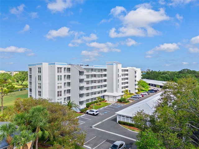view of building exterior featuring uncovered parking