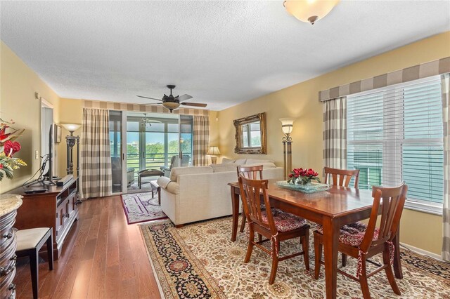 dining space with wood finished floors, ceiling fan, and a textured ceiling