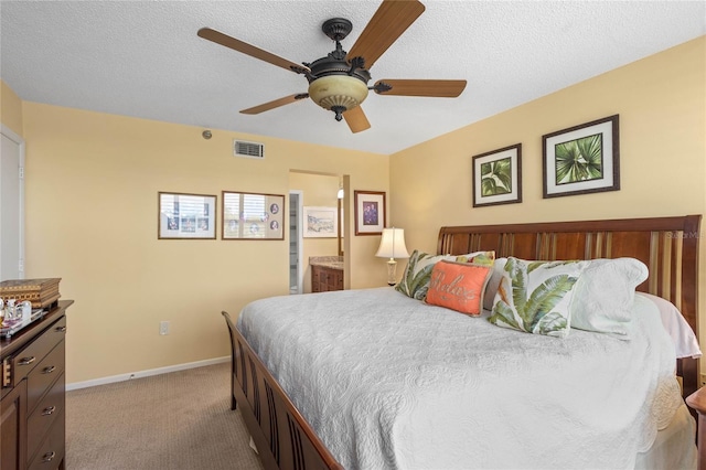 bedroom with baseboards, visible vents, carpet, and a textured ceiling