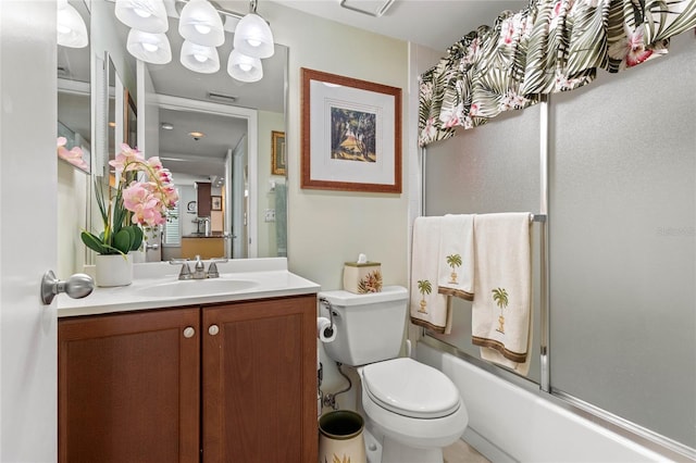 bathroom featuring enclosed tub / shower combo, visible vents, toilet, and vanity
