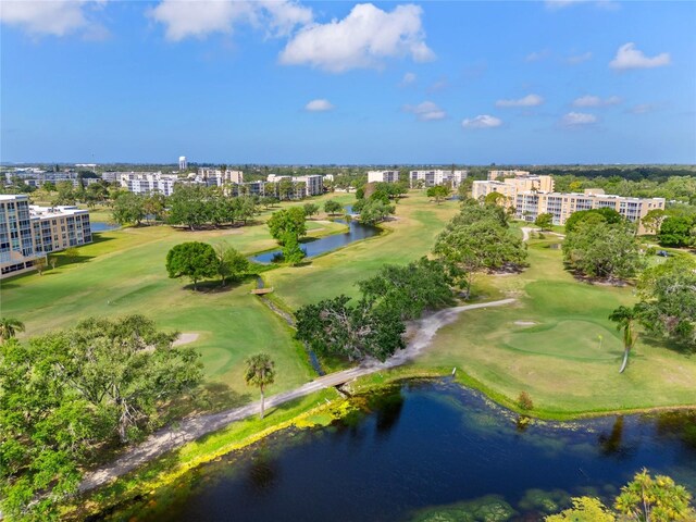 drone / aerial view with a water view and view of golf course