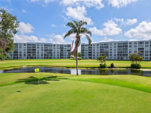 surrounding community featuring view of golf course, a water view, and a yard