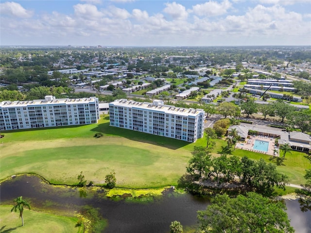 aerial view with golf course view, a water view, and a view of city
