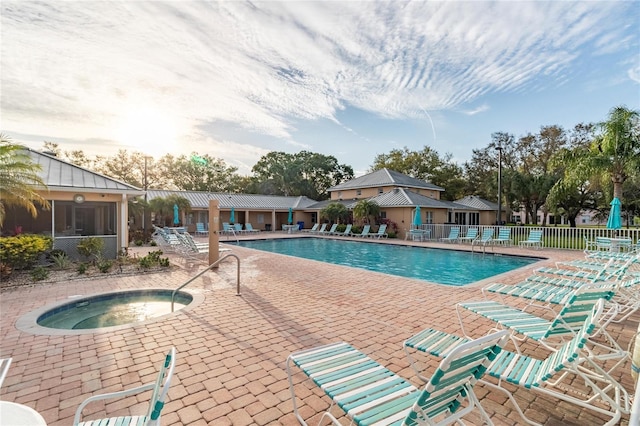 pool featuring a community hot tub, fence, and a patio area