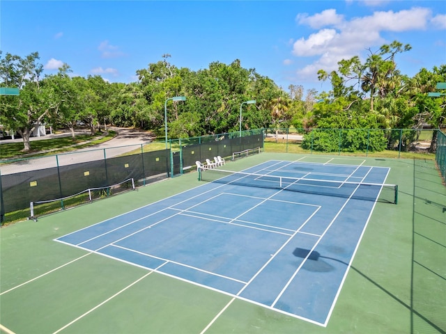 view of sport court featuring fence and community basketball court