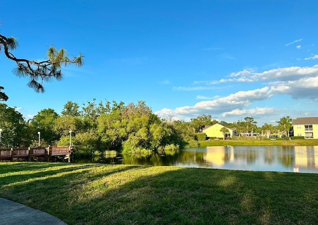 exterior space featuring a lawn and a water view