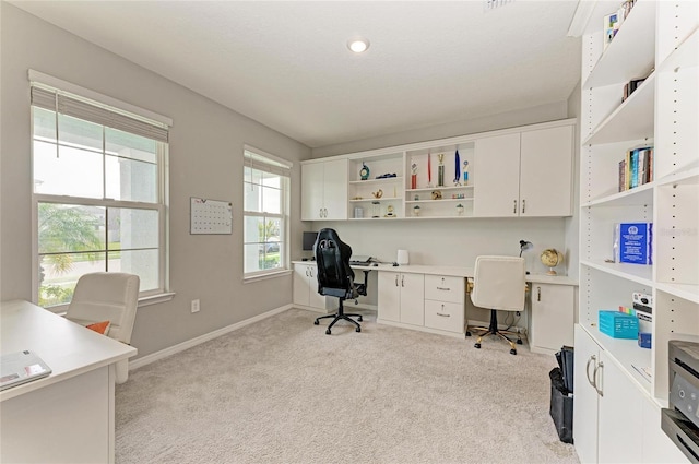 office featuring light carpet and baseboards