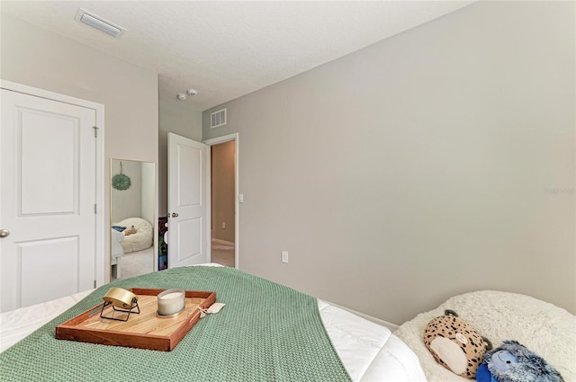 bedroom featuring baseboards, visible vents, and carpet