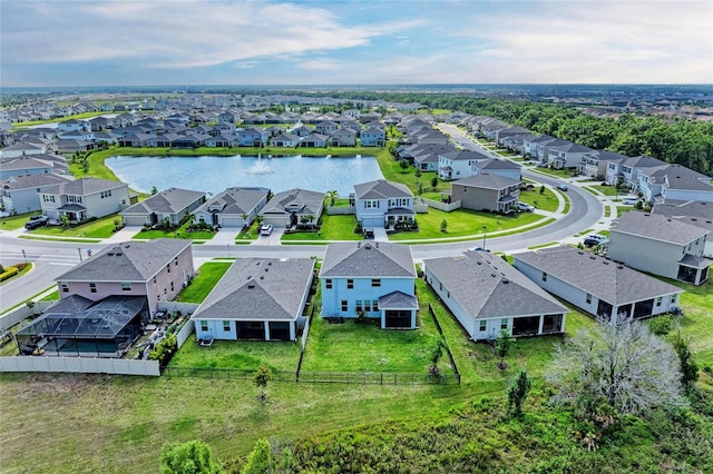 birds eye view of property with a water view and a residential view