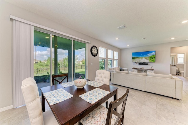 dining space with visible vents, a wealth of natural light, recessed lighting, and light tile patterned flooring