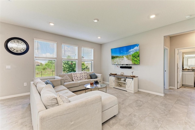 living room with baseboards and recessed lighting