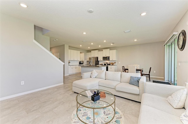 living room featuring recessed lighting and baseboards