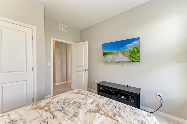 bedroom with visible vents and baseboards