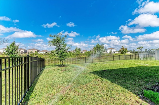 view of yard with a fenced backyard and a residential view