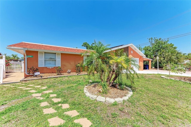 3053 Monica Pkwy, Sarasota, FL 34234 - single story home with fence, driveway, a front yard, and stucco siding