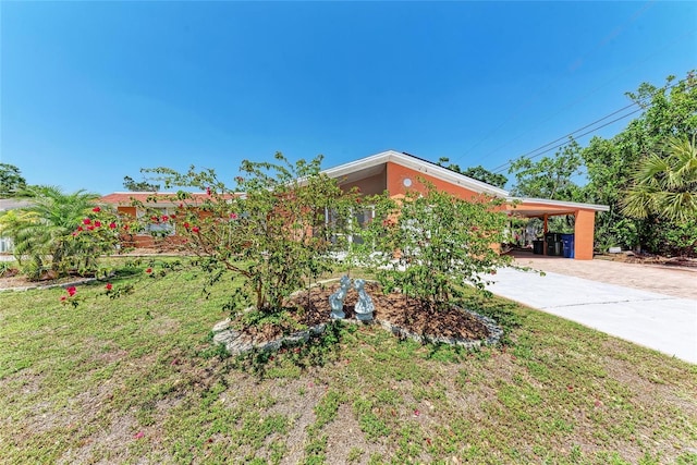 3053 Monica Pkwy, Sarasota, FL 34234 - view of property exterior with a lawn, an attached carport, and concrete driveway