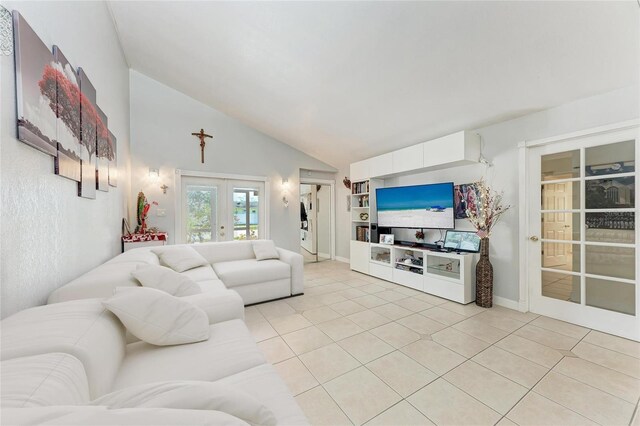 3053 Monica Pkwy, Sarasota, FL 34234 - living area featuring french doors, high vaulted ceiling, and light tile patterned floors