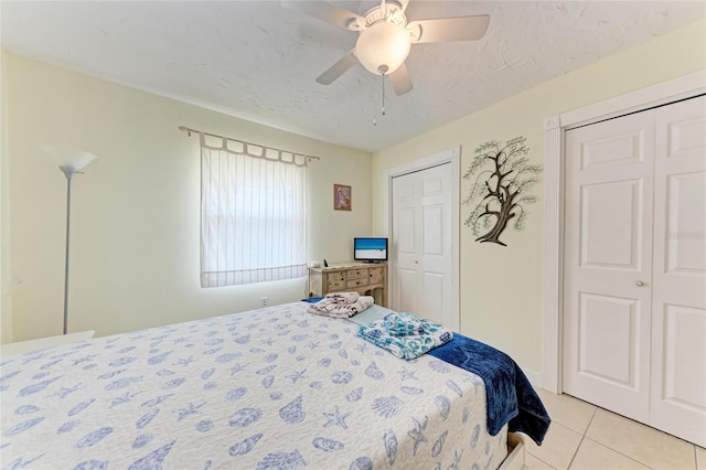 3053 Monica Pkwy, Sarasota, FL 34234 - bedroom with two closets, a ceiling fan, and light tile patterned floors