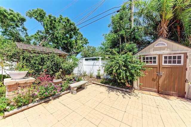 3053 Monica Pkwy, Sarasota, FL 34234 - view of patio with fence, a storage unit, and an outbuilding