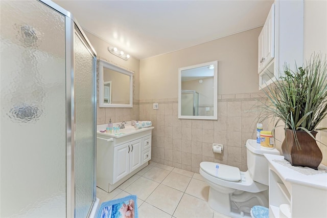 3053 Monica Pkwy, Sarasota, FL 34234 - full bathroom with tile patterned flooring, toilet, vanity, tile walls, and a stall shower