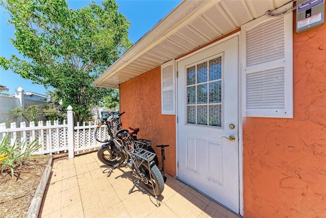 3053 Monica Pkwy, Sarasota, FL 34234 - property entrance with a patio, stucco siding, and fence