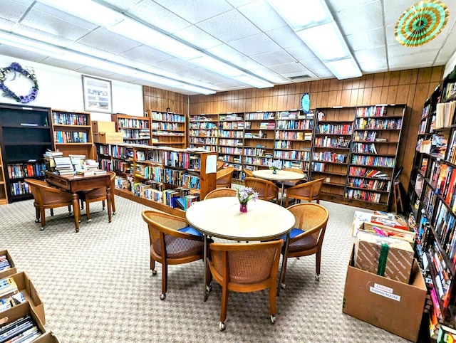 3409 Montilla Ct Unit 8410, Sarasota, FL 34232 - sitting room with wood walls, carpet, and bookshelves