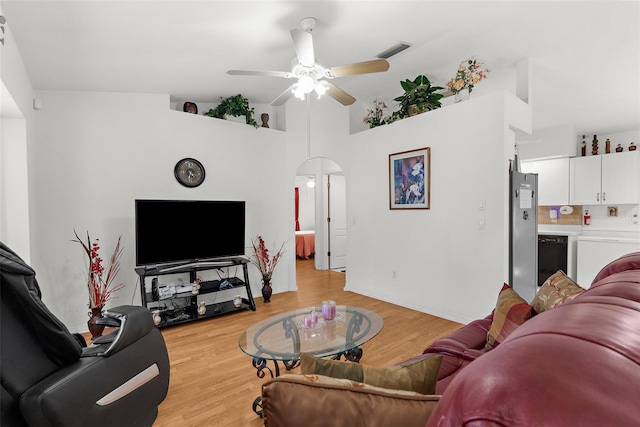 3459 Lotus Rd, North Port, FL 34291 - living room featuring a ceiling fan, light wood finished floors, washer / clothes dryer, visible vents, and arched walkways