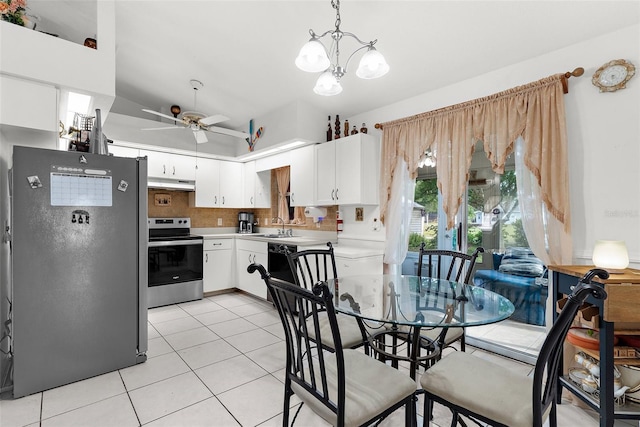 3459 Lotus Rd, North Port, FL 34291 - kitchen with light countertops, under cabinet range hood, light tile patterned flooring, a sink, and appliances with stainless steel finishes