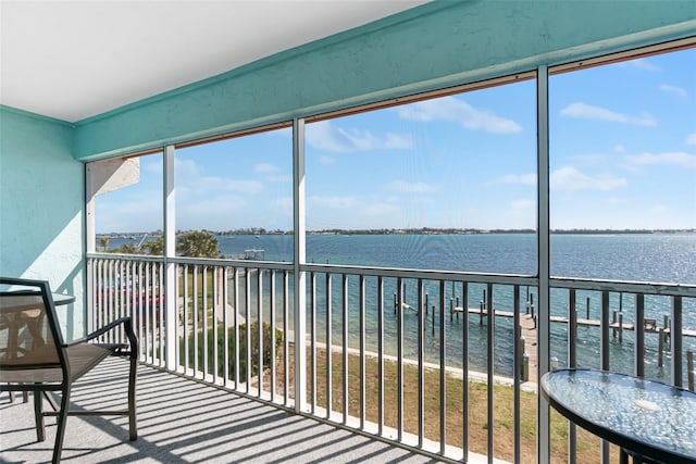 unfurnished sunroom featuring a water view