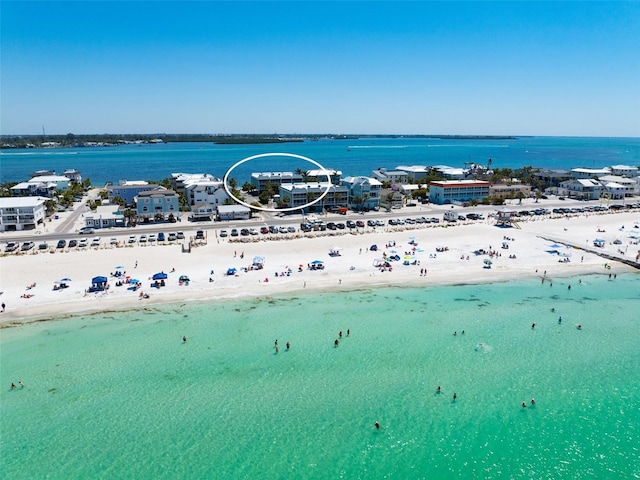 bird's eye view featuring a beach view and a water view