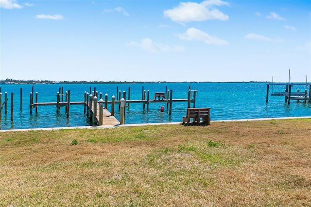 view of dock featuring a yard and a water view