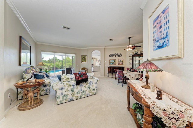 8136 Snowy Egret Pl, Bradenton, FL 34202 - living room with arched walkways, light carpet, crown molding, and a ceiling fan