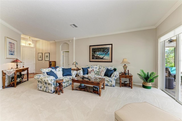 8136 Snowy Egret Pl, Bradenton, FL 34202 - carpeted living room with crown molding and arched walkways