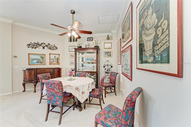 8136 Snowy Egret Pl, Bradenton, FL 34202 - dining area with crown molding, attic access, light colored carpet, and a ceiling fan