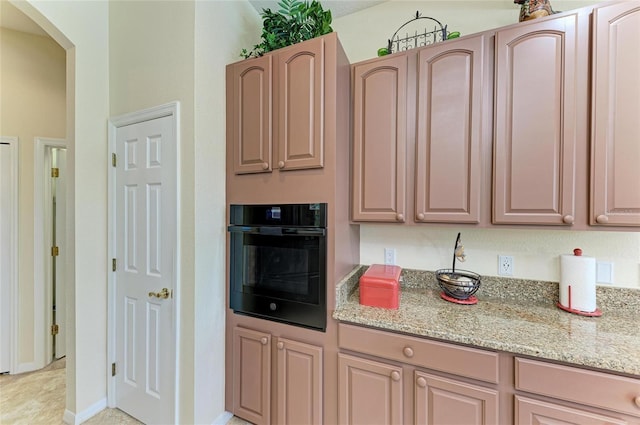 8136 Snowy Egret Pl, Bradenton, FL 34202 - kitchen featuring oven, light stone counters, and arched walkways