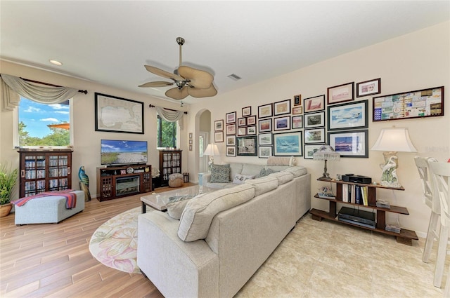 8136 Snowy Egret Pl, Bradenton, FL 34202 - living room with arched walkways, a ceiling fan, light wood-style floors, and recessed lighting